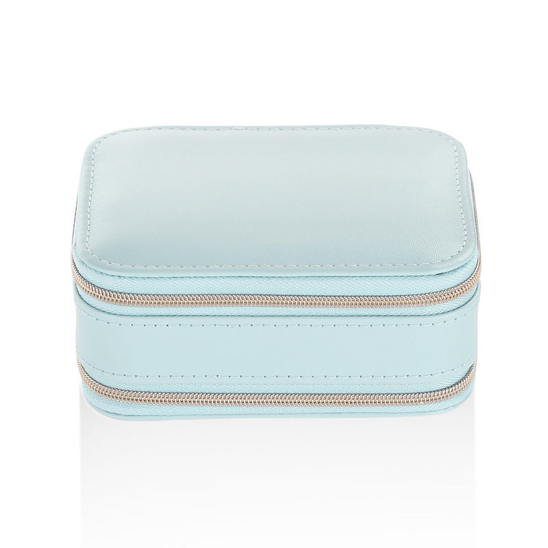 Blue compact travel jewelry case with two zippered sections