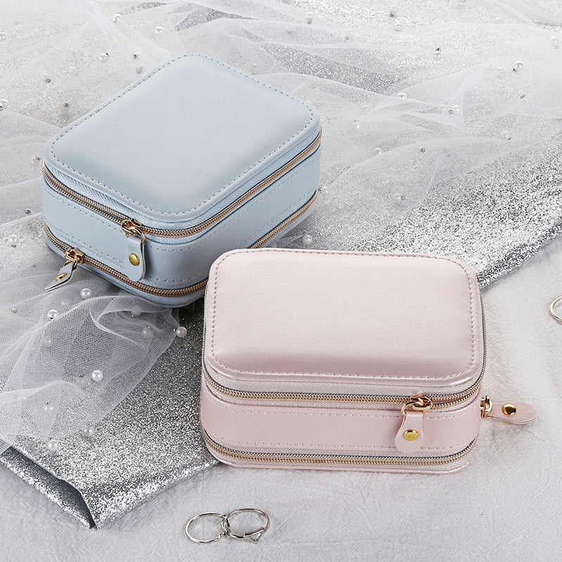 Blue and pink travel jewelry cases shown together; each sold separately
