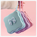 Blue, purple, and pink bow cable organizer pouches with wrist straps; each sold separately