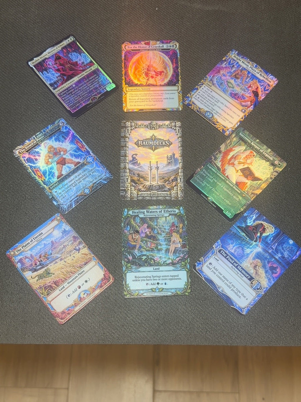 Sword of Eternia by BaumDecks — actual printed foil cards and Castle Grayskull card back under display lighting.